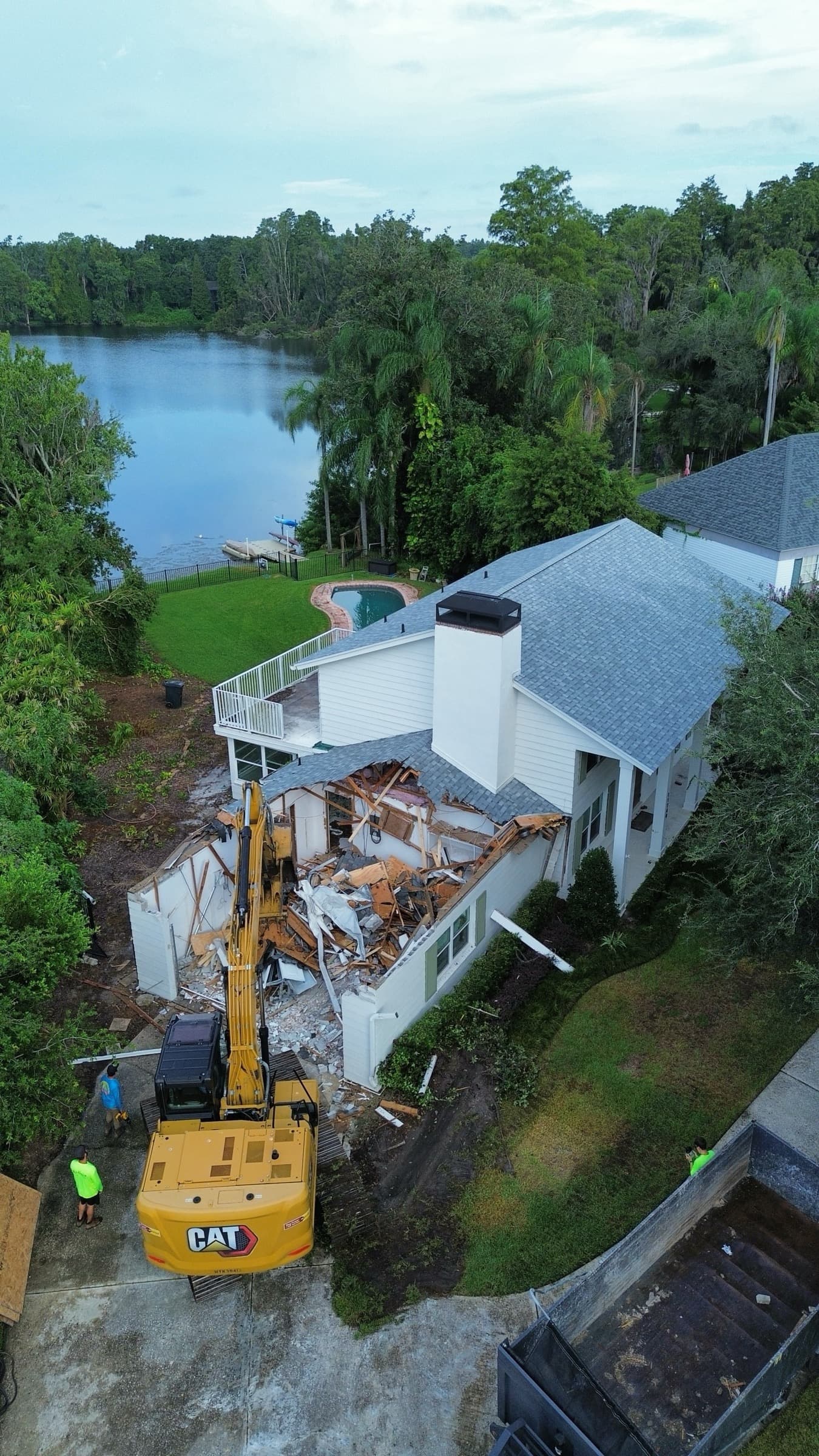 Waterfront demolition site with Mojo equipment and cleared debris